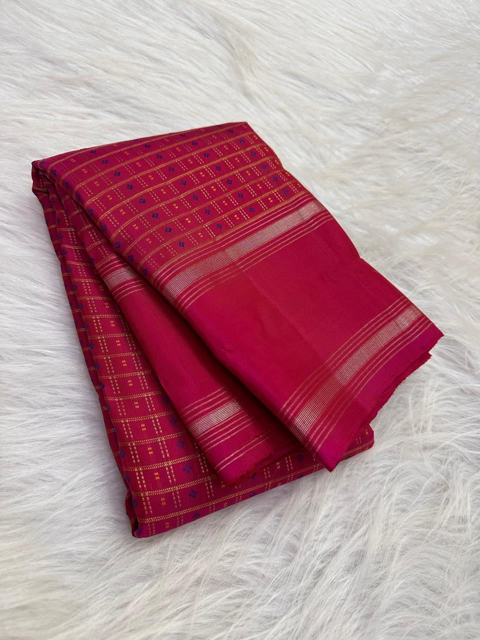 Handwoven raspberry pink KanchiPattu saree showcasing the all-over 1000 Butta design.