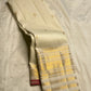 Folded ivory pure silk Kanchipuram Butta saree showing zari buttas and border