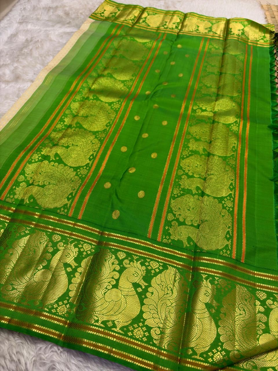 Soft ivory Kanjipuram saree pallu with emerald green zari peacock detailing