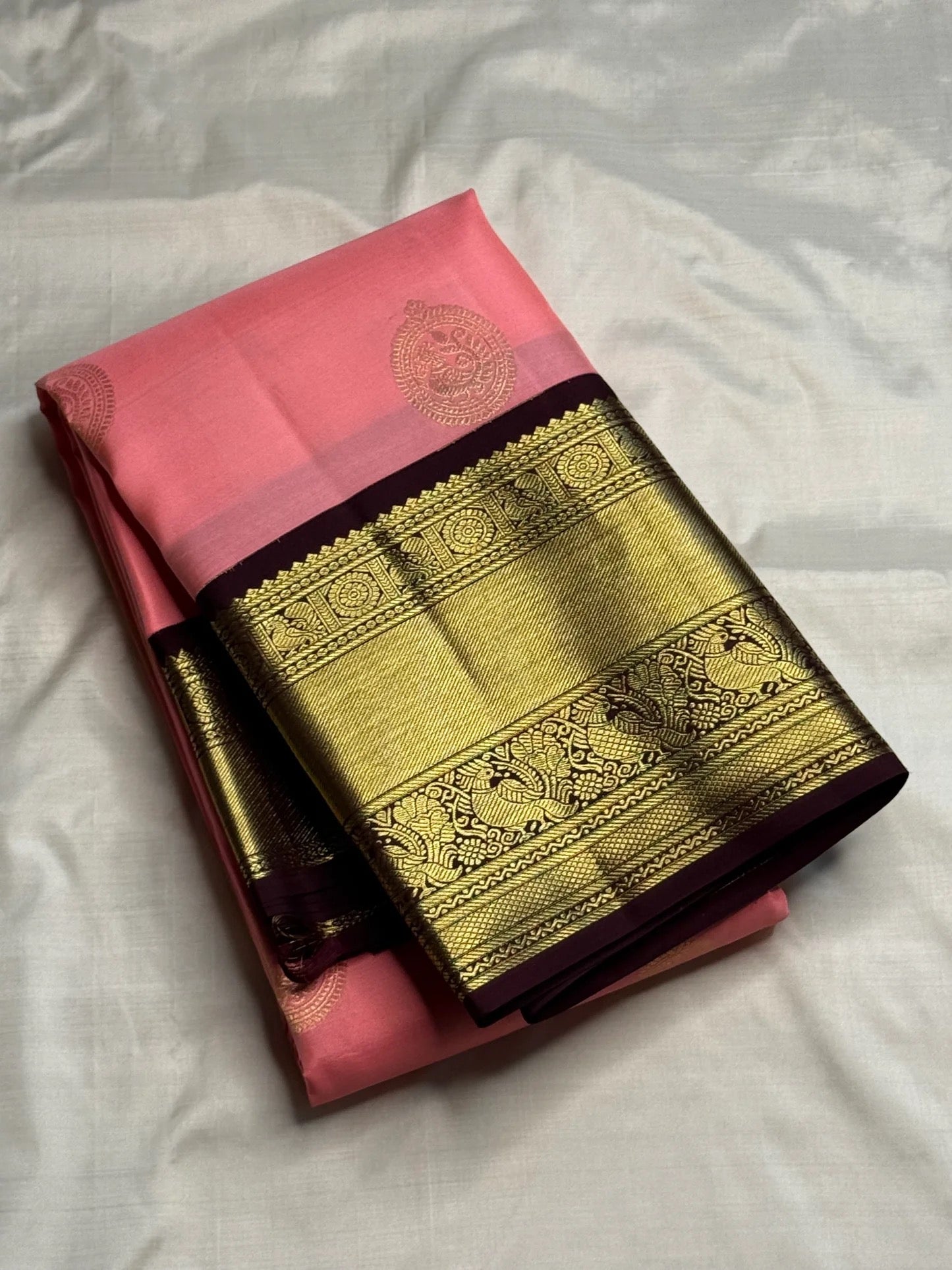 Close-up of mayil peacock zari buttas on blush pink Kanchi Pattu Korvai silk saree body