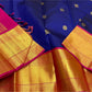 Close-up of blue saree body with gold zari buttas, gold zari border with pink edge, and visible tassels near the pallu.