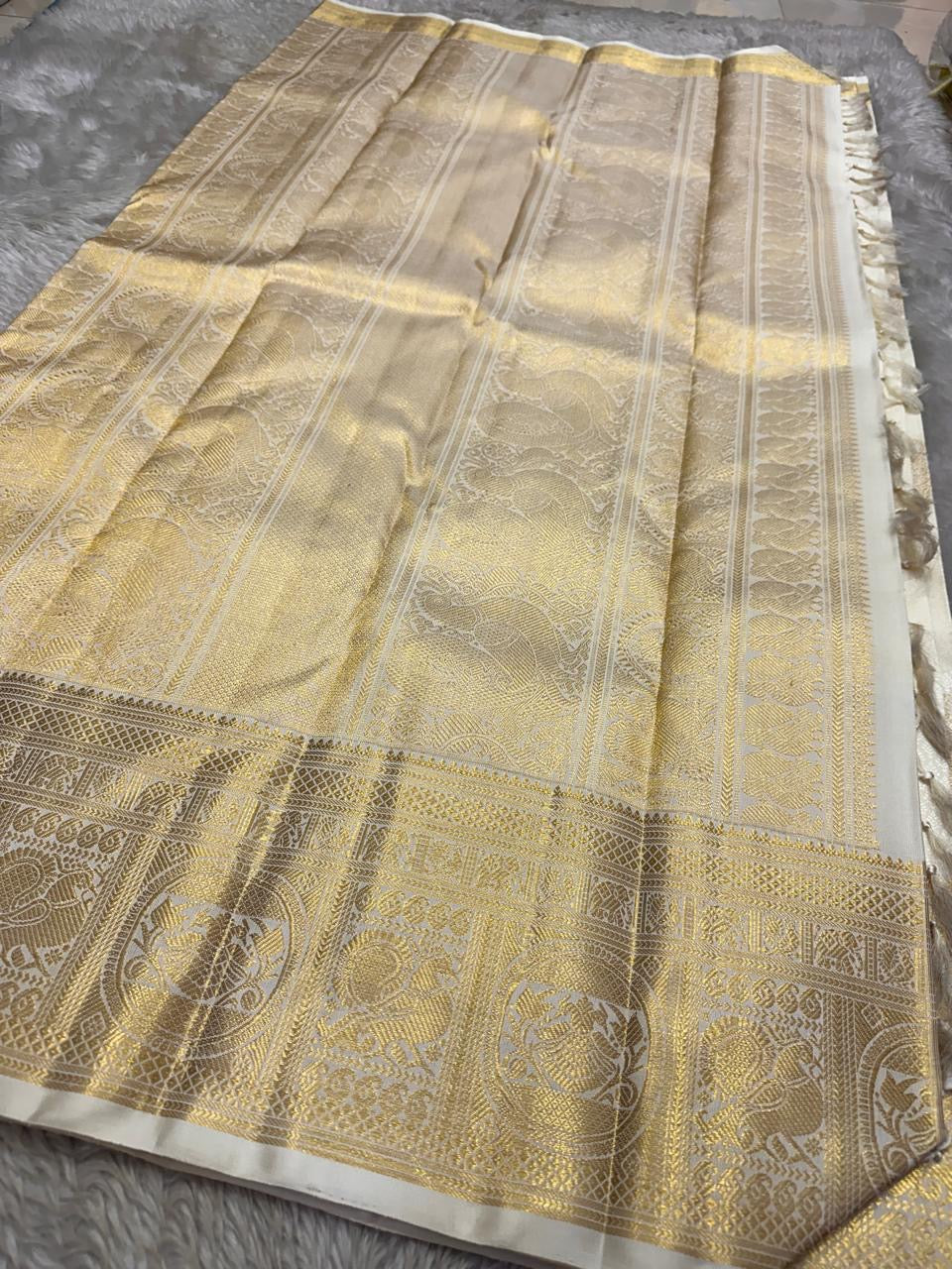 Full view of gold zari pallu spread on ivory Pure Kanchipuram Silk Saree, available in the USA.