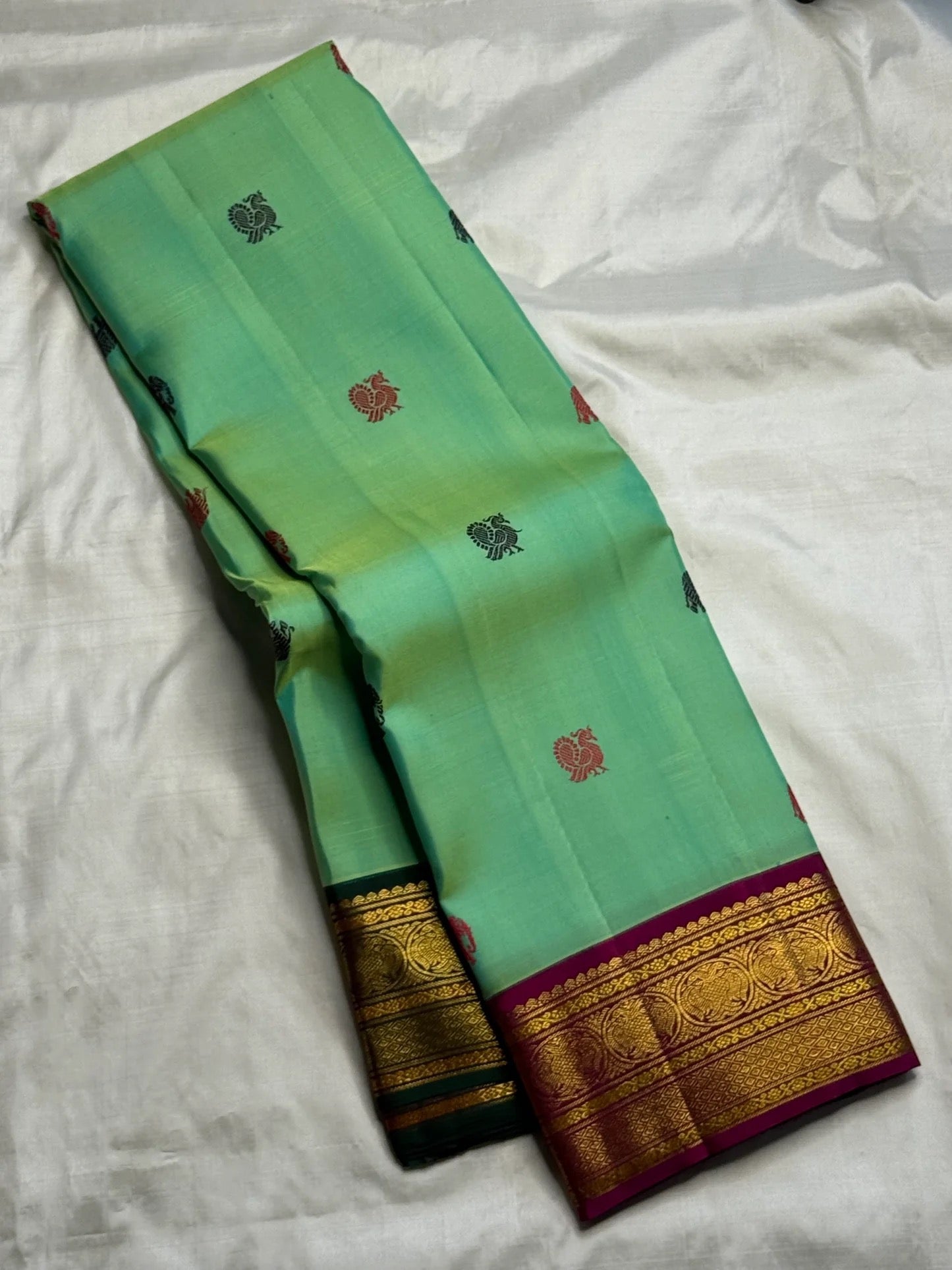 Pallu detail of mint green Kanchi Pattu Butta saree with Ganga Jamuna treatment