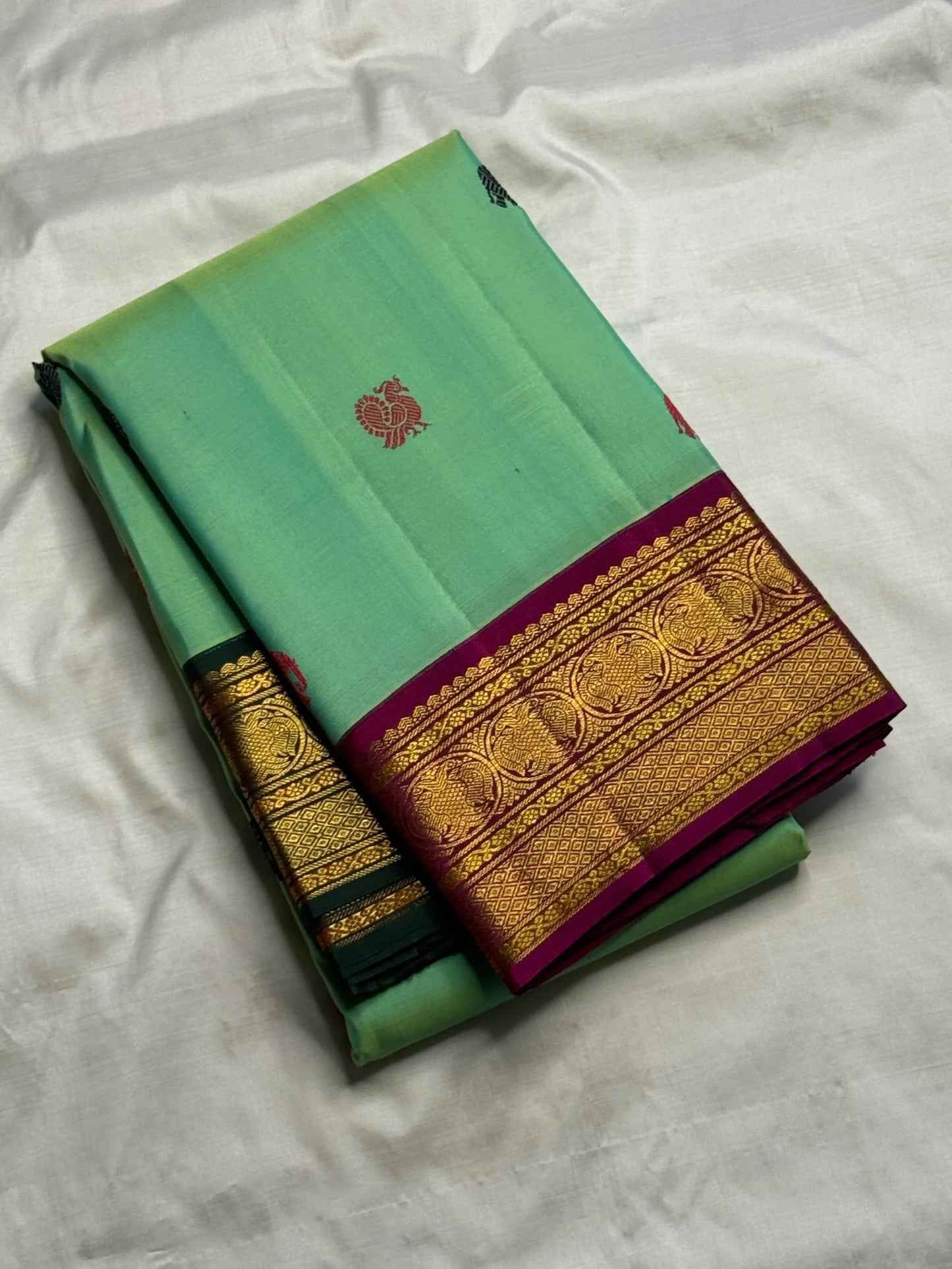 Mint green Kanchi Pattu Butta saree folded view — Idam Living