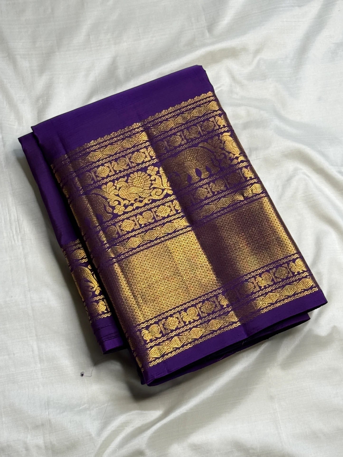 Restrained body close-up of royal purple Kanjipuram Butta saree