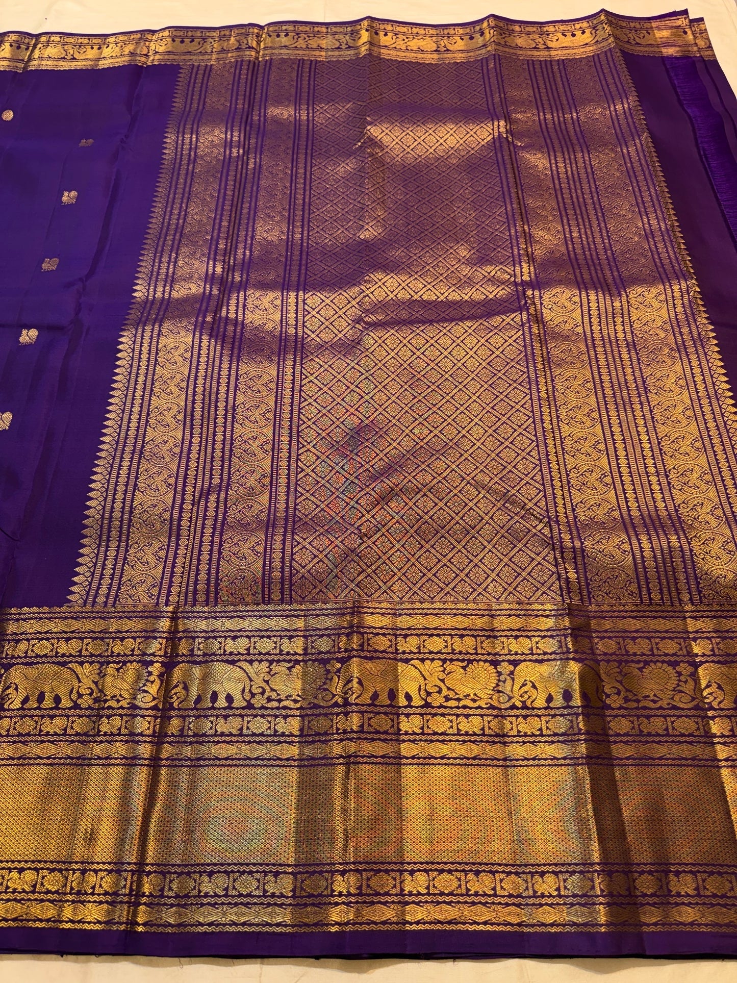 Zari motif detail close-up on royal purple Kanjipuram Butta saree