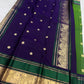 Leaf green Kanjivaram silk saree folded, showing Butta motifs and peacock border