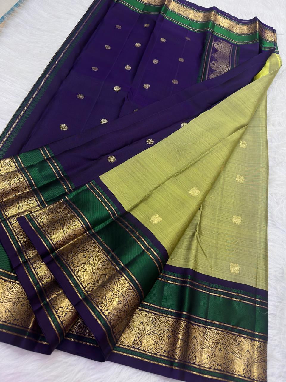 Emerald green and aubergine-purple Vanasringaram peacock border on sage olive green KanchiPattu saree