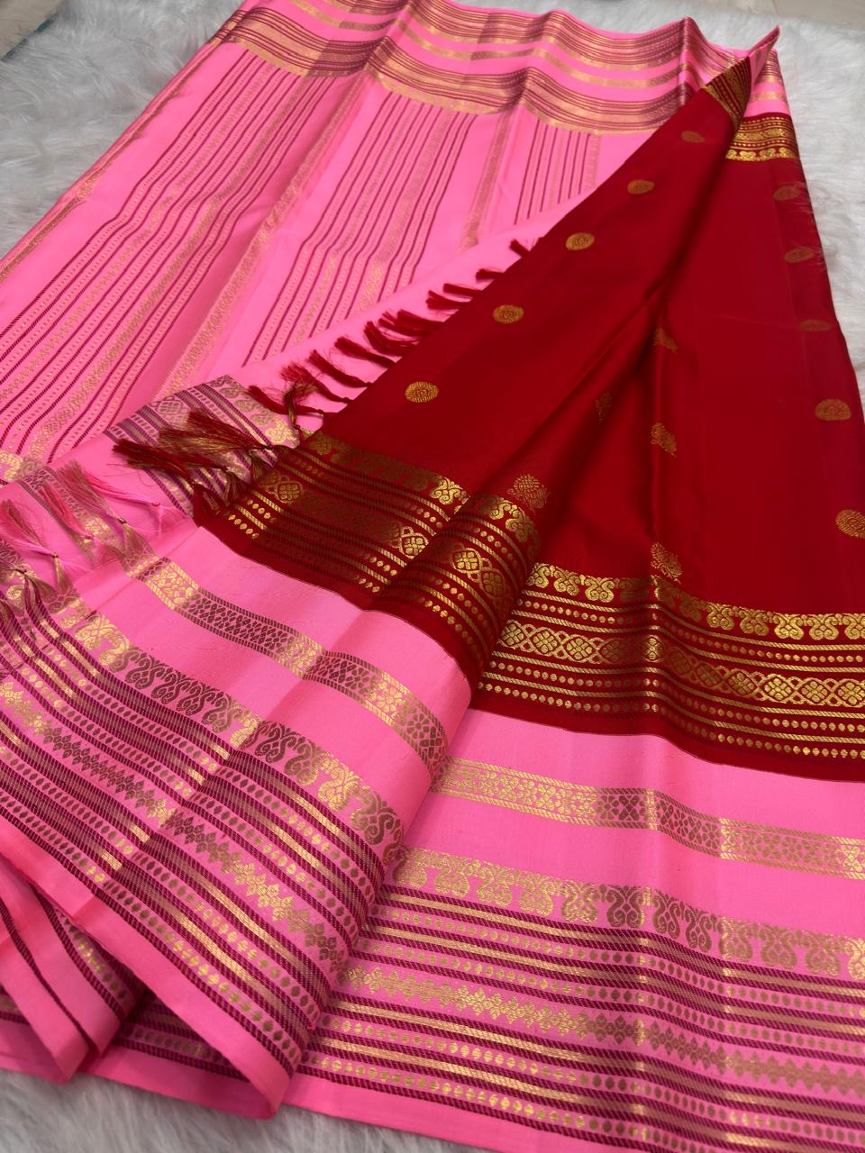 Pallu detail of pink Kanjeevaram Korvai saree with geometric and floral zari panels