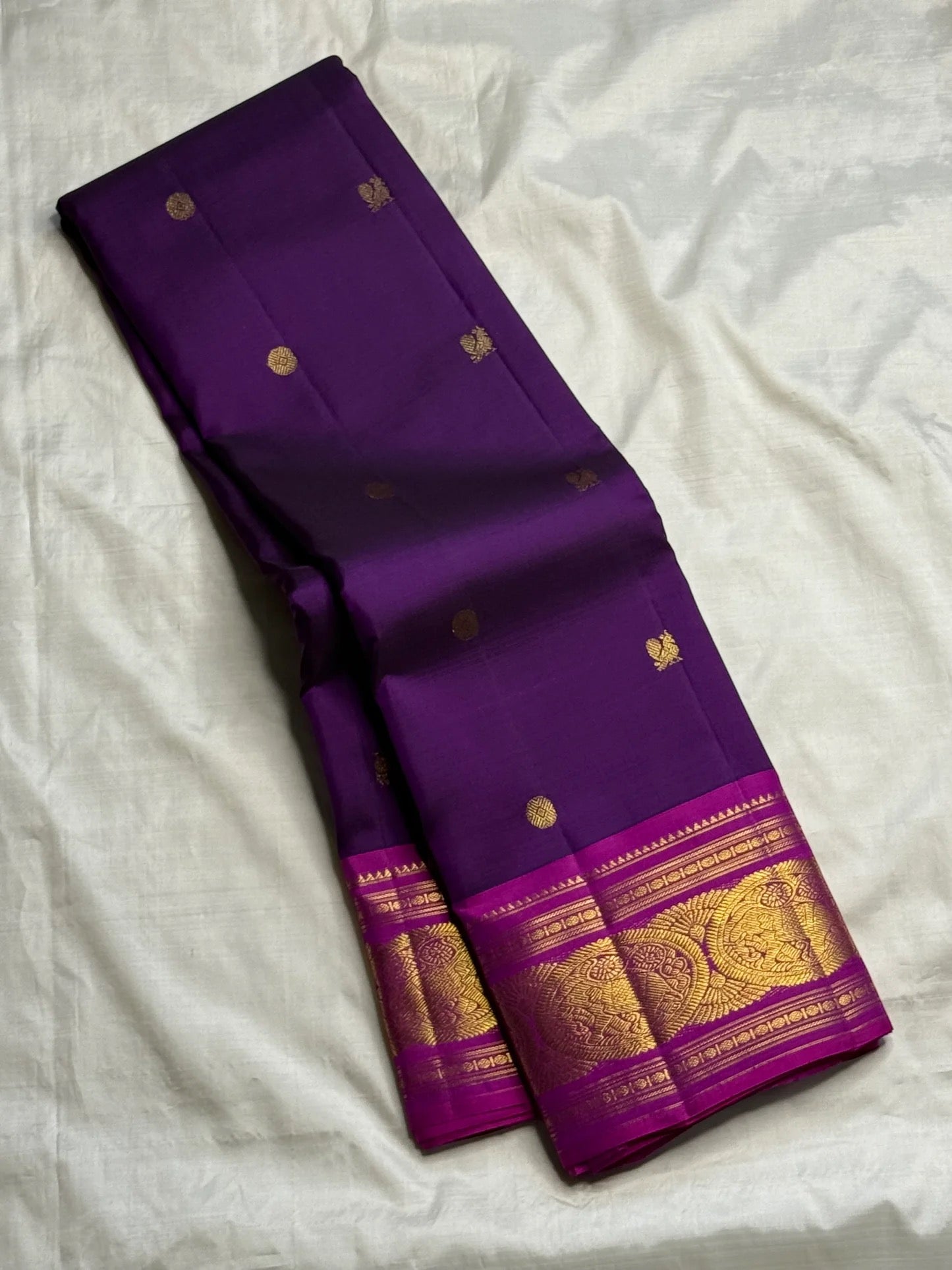 Body close-up of royal purple Kanjipuram saree showing petite gold zari buttas