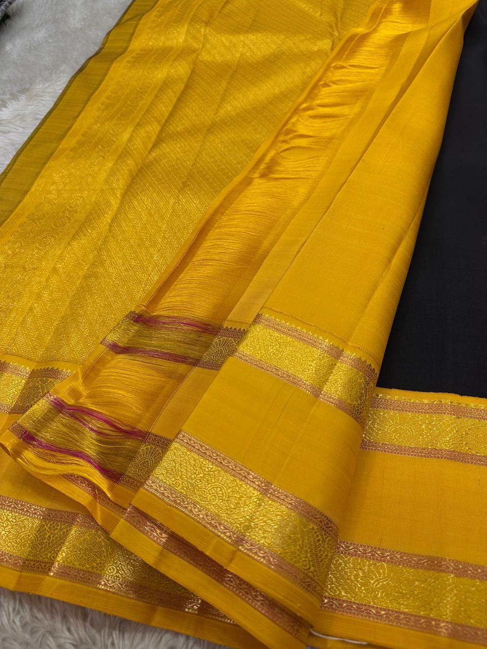 Handwoven Kanchipuram silk saree in navy with classic gold zari detailing and contrast pink pallu