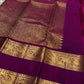 Body close-up of deep forest green Kanjeevaram saree showing gold zari buttas