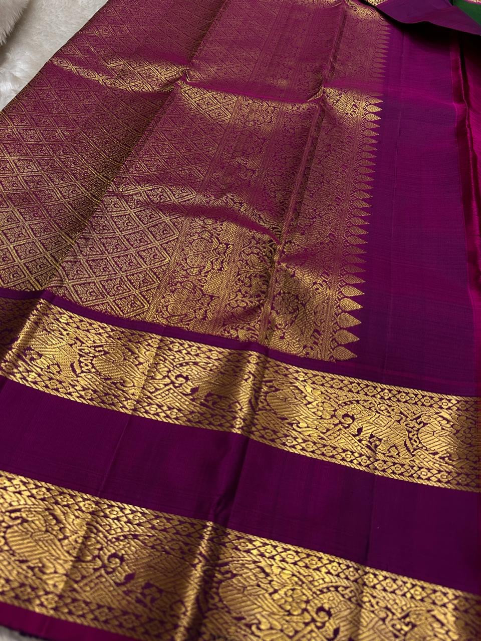 Body close-up of deep forest green Kanjeevaram saree showing gold zari buttas