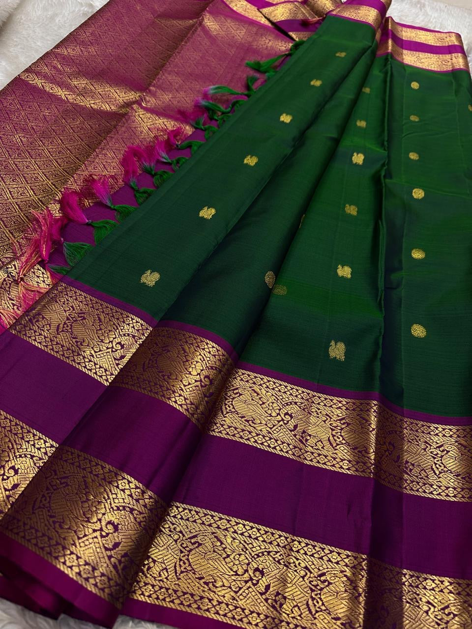 Pallu detail of deep forest green Kanjeevaram Rettapet saree with matching zari work