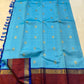 Brick-red Rettapet twin-line border with royal-blue edging on turquoise blue Kanjipuram saree