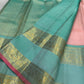 Blush rose Kanjivaram silk saree folded, showing peacock teal border contrast