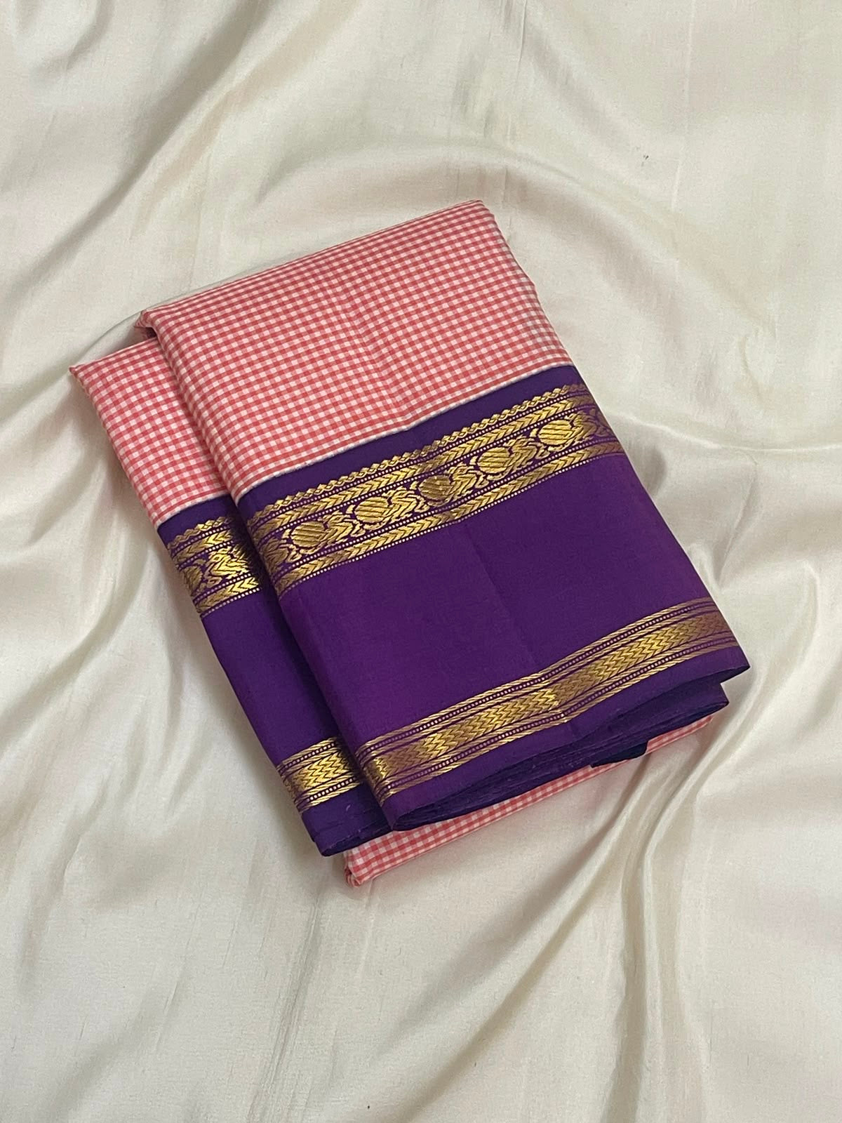 Royal purple zari border detail showing geometric panels on the Kanchi Pattu saree.
