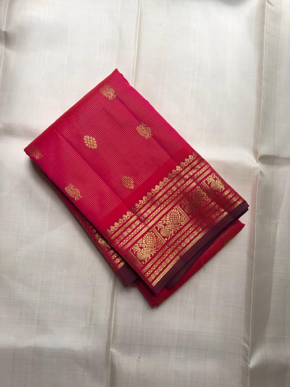 Raspberry pink KanchiPattu silk saree — radiant silk weave texture close-up