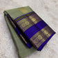 Royal violet-blue Rettapet border detail on the sage green Kanchipuram saree.