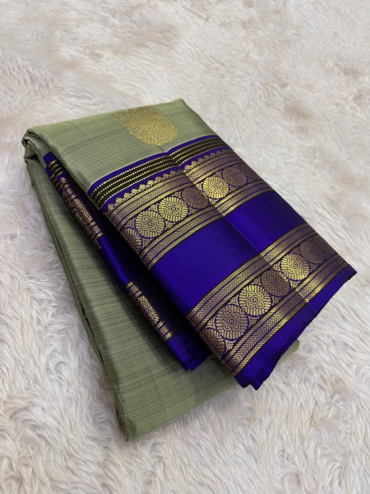 Royal violet-blue Rettapet border detail on the sage green Kanchipuram saree.