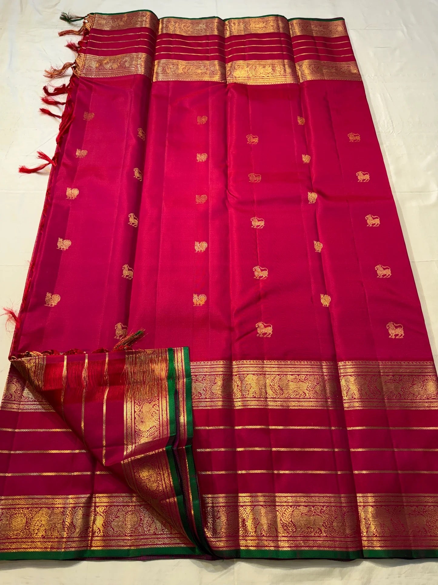 Emerald selvedge Kanjivaram saree with antique gold woven zari work.
