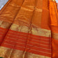 Close view of vermilion orange pure Kanchipuram silk saree with gold zari stripes and ornate zari border