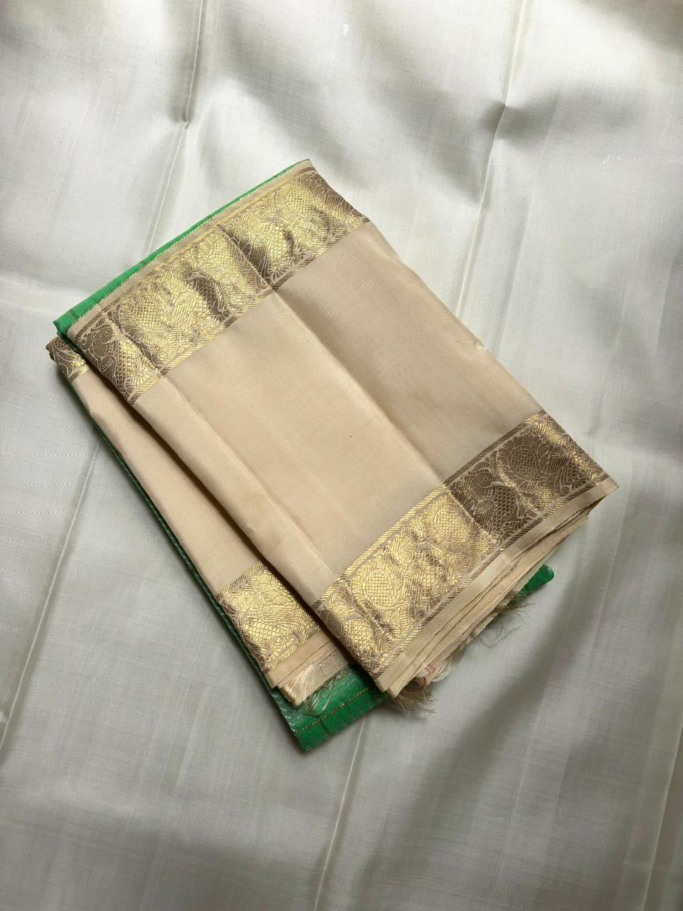 Pallu detail of fresh green Kancheepuram Zari Kattam saree in ivory-gold