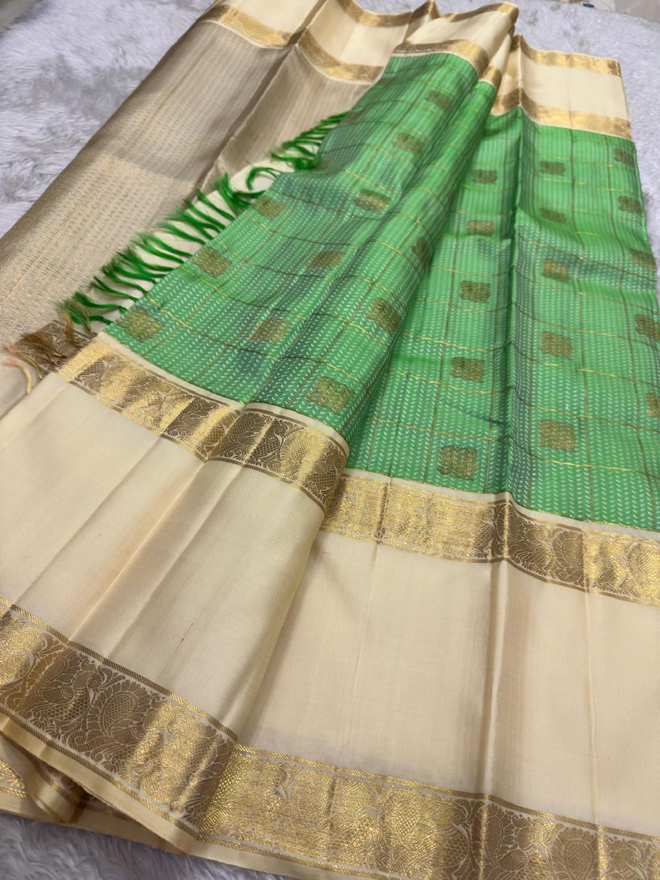 Zari grid detail close-up on fresh green Kancheepuram saree