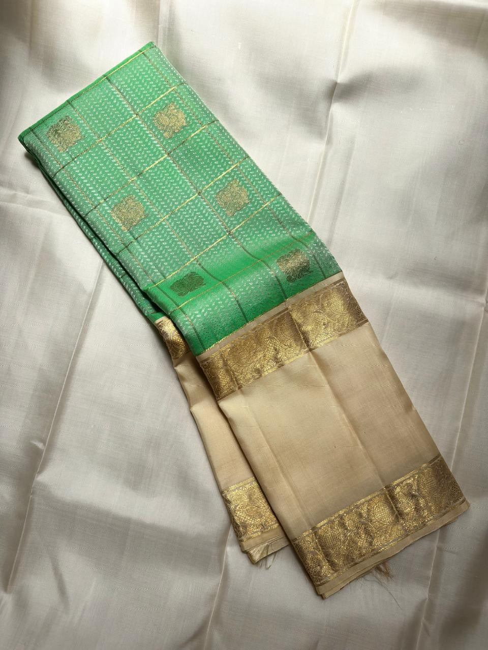 Ivory-gold border detail second angle on fresh green Kancheepuram saree