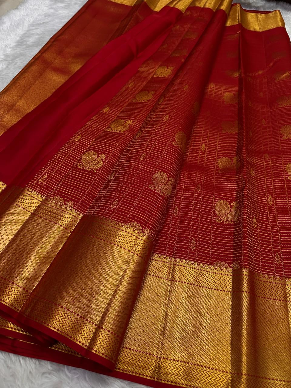 Close-up of zari kattam checks on pillar box red Kancheepuram silk saree
