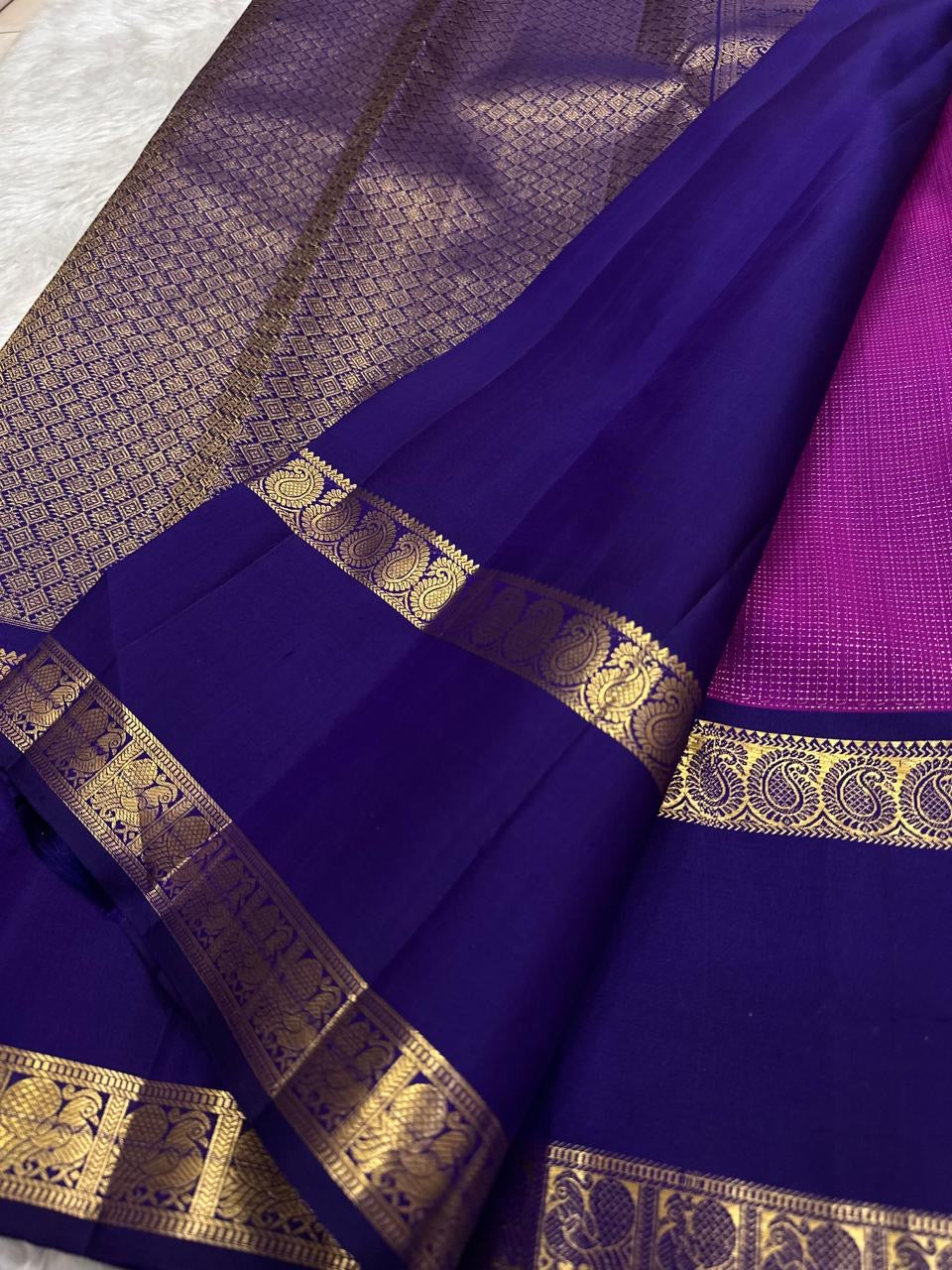 Royal purple Rettapet border detail with antique-gold zari paisley motifs on raspberry pink Kanjivaram saree