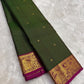 Forest green handwoven pure silk Kanchipuram saree with raspberry pink zari border, full view