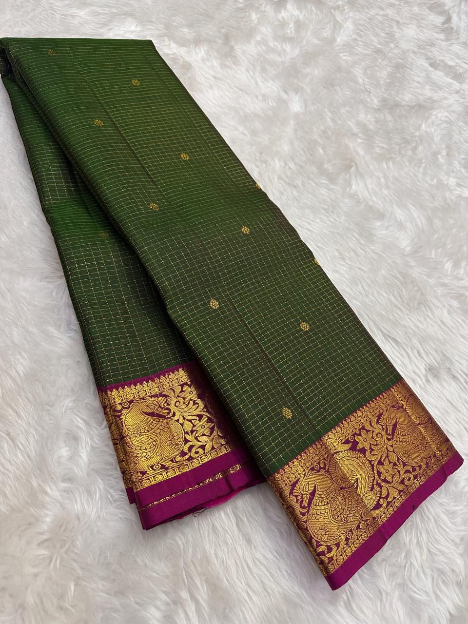 Forest green handwoven pure silk Kanchipuram saree with raspberry pink zari border, full view