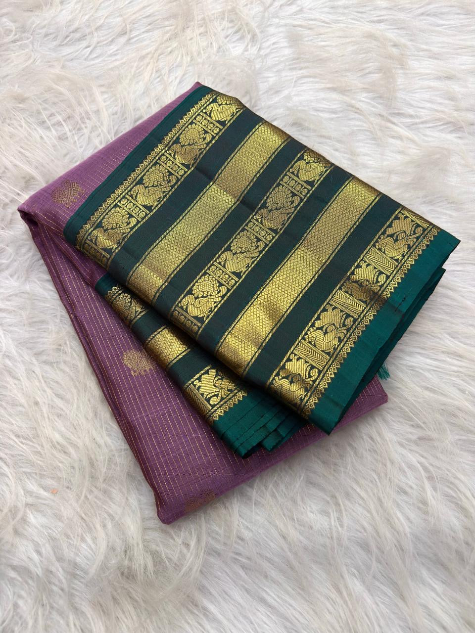 Lavender pure mulberry silk body with fine oosivaanam gold zari lines and spaced circular buttas