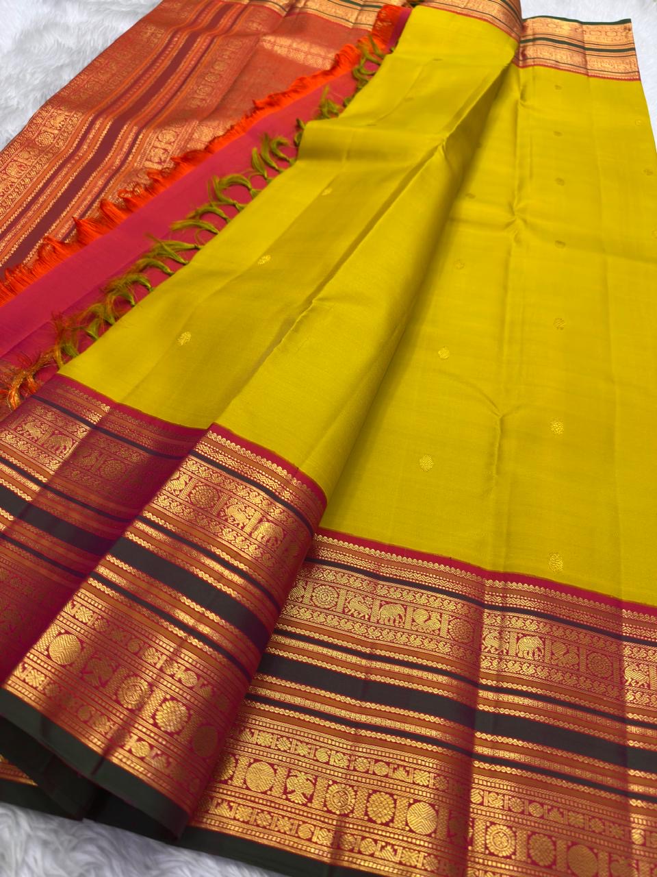 Raspberry Korvai elephant motif detail on Turmeric Gold Kanjivaram silk saree