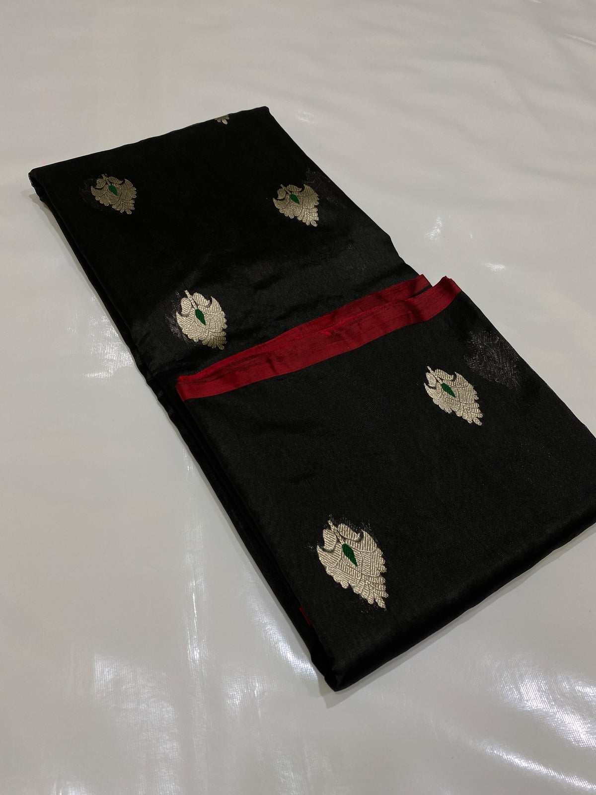 Fine silver edge along the border of a midnight black Chanderi Pattu Silk saree