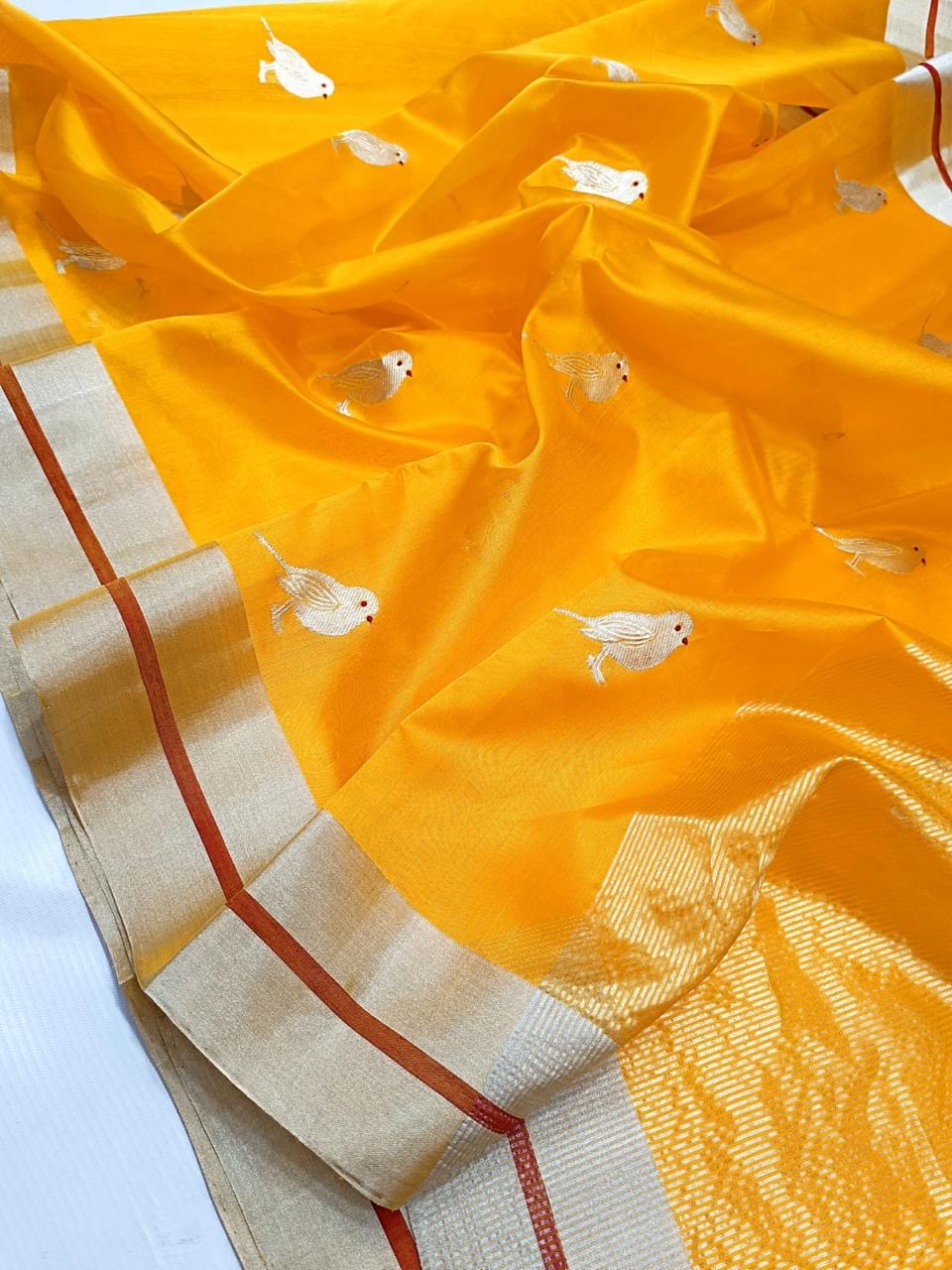 Marigold yellow Chanderi Pattu Silk saree with ivory bird motifs, silver-gold borders and rust-red edge stripes