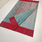 Side view drape of lagoon-blue Chanderi Tissue Silk saree with bright crimson border