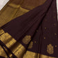 Ornate self-colour border of deep chocolate brown Kanjipuram saree with dense Maanga and floral antique gold zari array