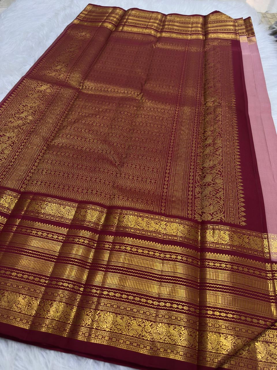 Dusty rose Kanchi Pattu saree pallu with ornate maroon zari border detail