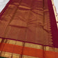 Folded warm ivory Kanjivaram silk saree with gold twin bird buttas and contrasting Korvai border.