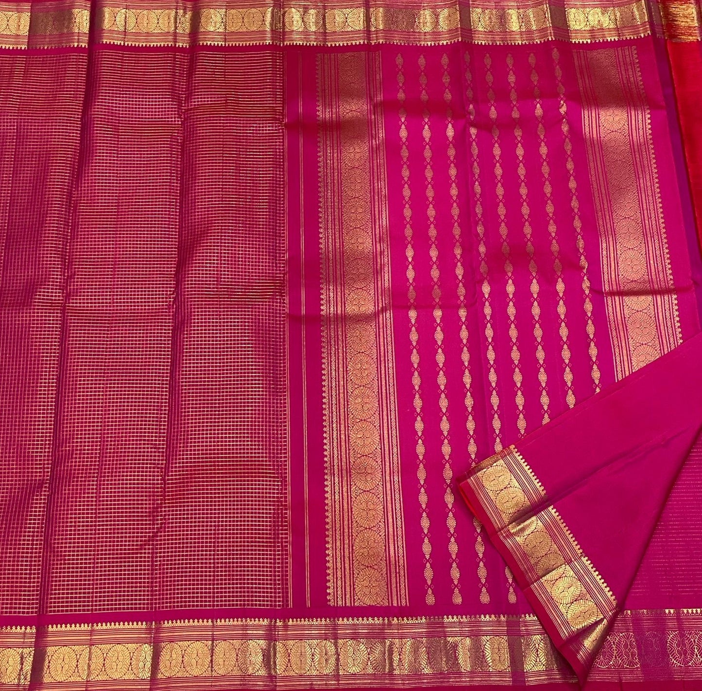 Folded view of radiant pink Kanjivaram saree with Zari Kattam weave and multicolour border — Idam Living