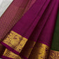 Raspberry pink peacock zari border detail on forest green Kanchipuram saree