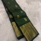 Handwoven Pure Silk Kanchipuram saree in deep maragatham green with a soft petal pink pallu with petite Gandaberunda zari buttas.
