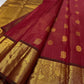 Full view of bright vermilion red with a luminous petal pink pallu Kanchipuram saree showing airy butta placement across the body.