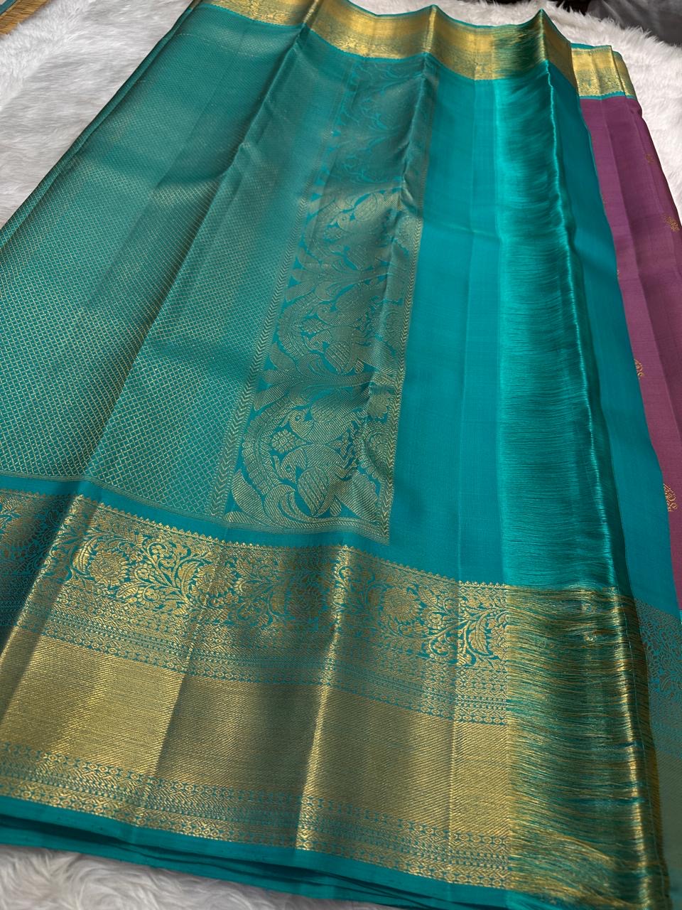 Pure Silk Kanjeevaram Butta saree with Maanga motifs and jewel-toned turquoise contrast