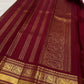 Burgundy Kanjivaram silk saree with floral vine Jaal and stylized Mayil-inspired gold zari motifs