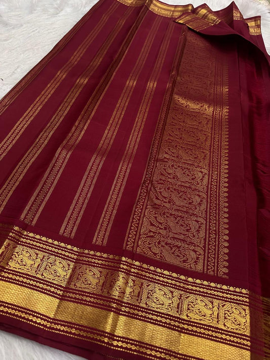 Burgundy Kanjivaram silk saree with floral vine Jaal and stylized Mayil-inspired gold zari motifs
