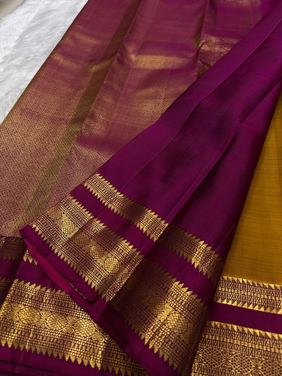 Pure Silk Kanchipuram Butta saree with antique gold zari buttas and purple border