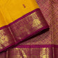 Handwoven Kanjivaram pure silk saree in mustard yellow with small green and pink silk-thread buttas and gold zari Korvai border